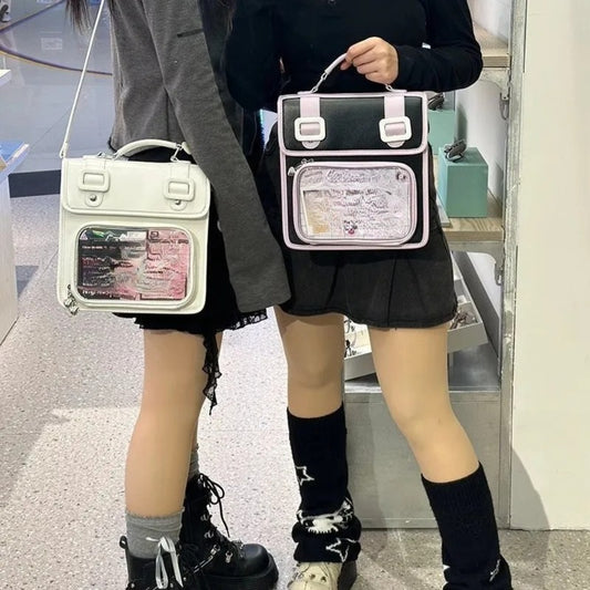 Two people holding white and black-pink satchel ita bags