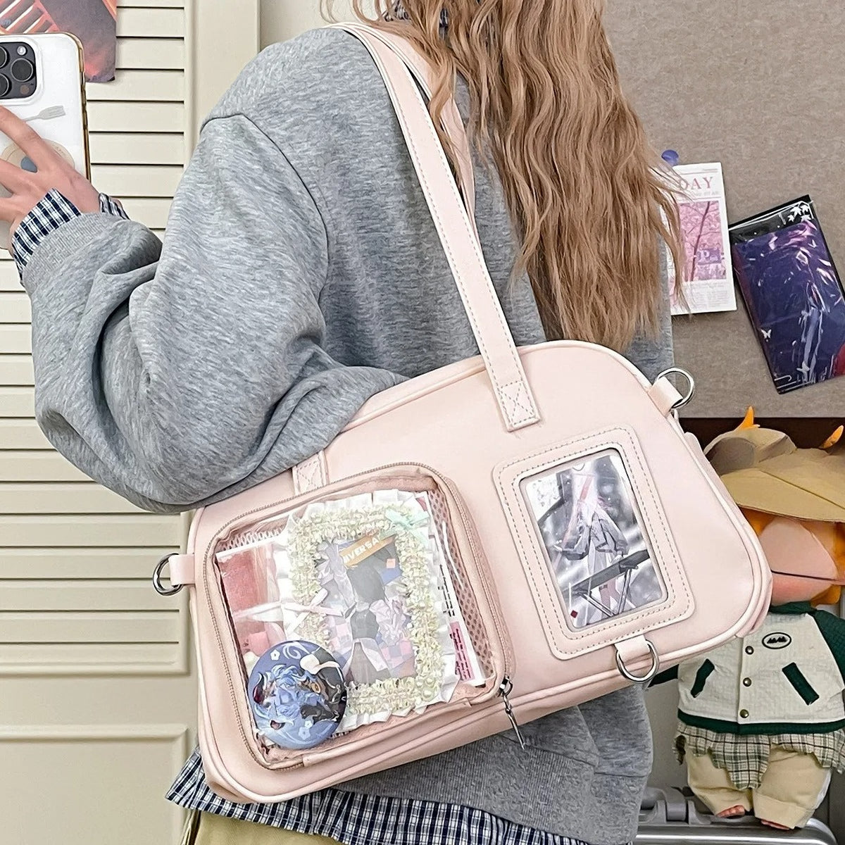 Pink dual window ita bowling bag worn crossbody with pins