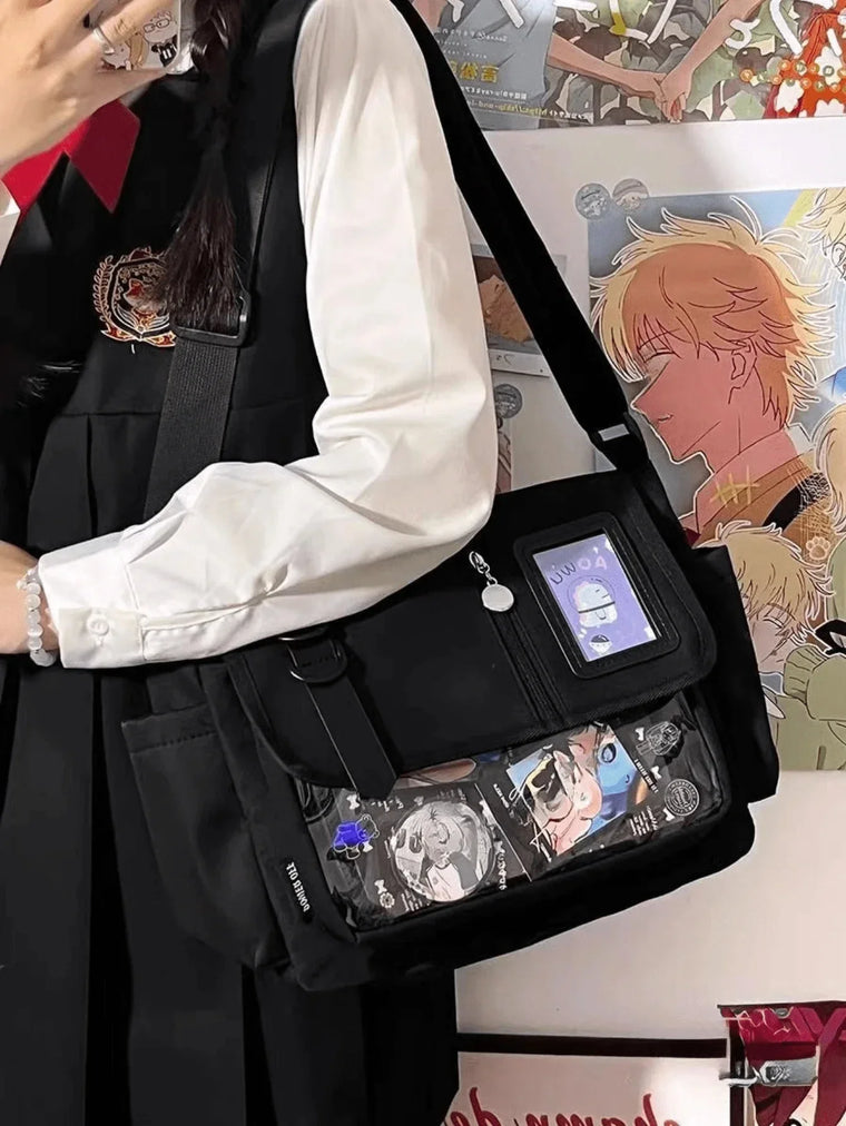 Black ita messenger bag worn crossbody with a photocard and character display in the clear window