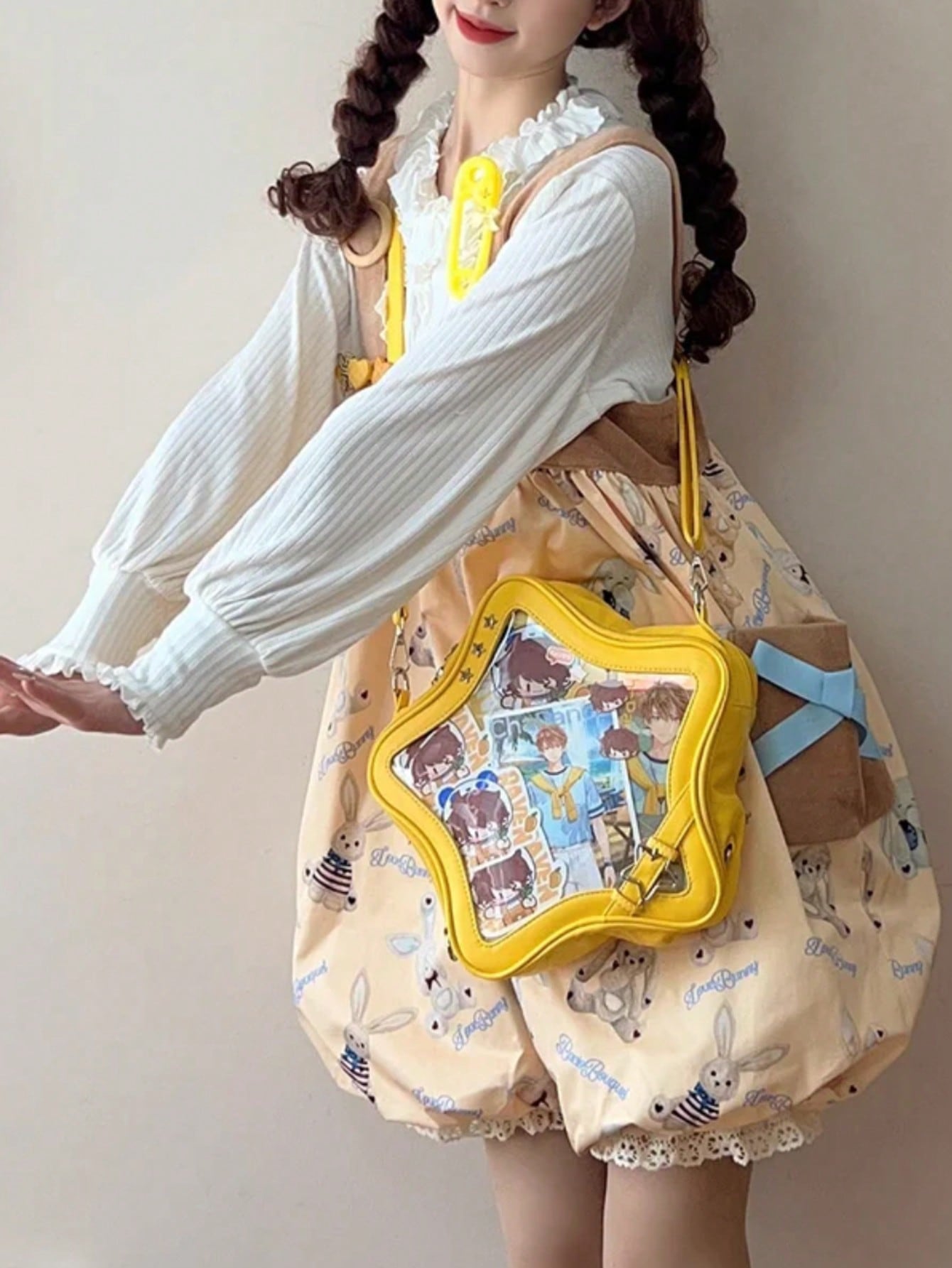 Person wearing yellow star display bag with prints