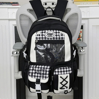  Black and white Miusi ita backpack on white chair, front view
