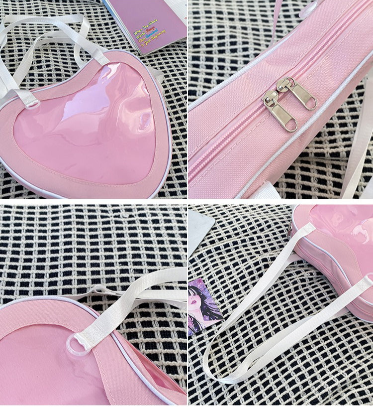 heart ita bag detail showing clear window edge gold zipper white strap and transparent ring hardware