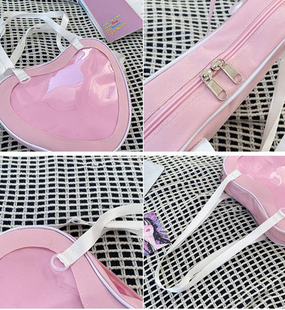 heart ita bag detail showing clear window edge gold zipper white strap and transparent ring hardware