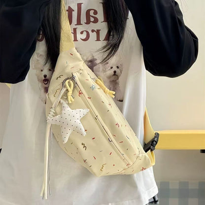 Cream chest bag with star charm worn crossbody