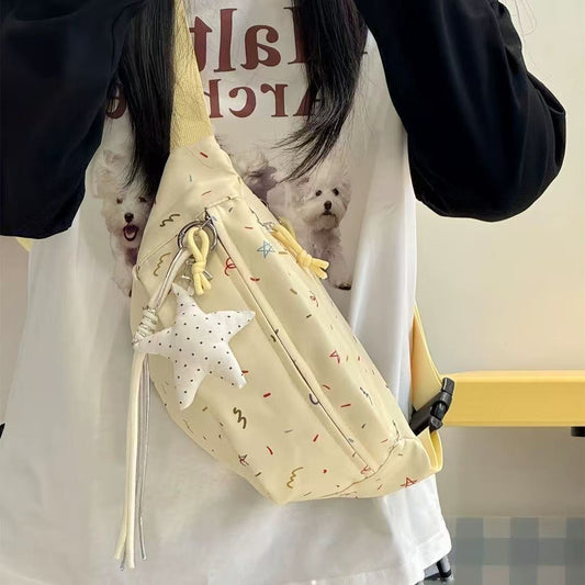 Cream chest bag with star charm worn crossbody