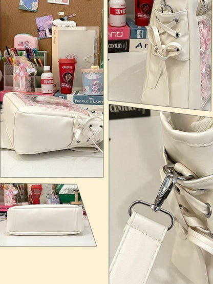 ita bag side lace-up corset detail silver grommets structured base and clip hook hardware close-up