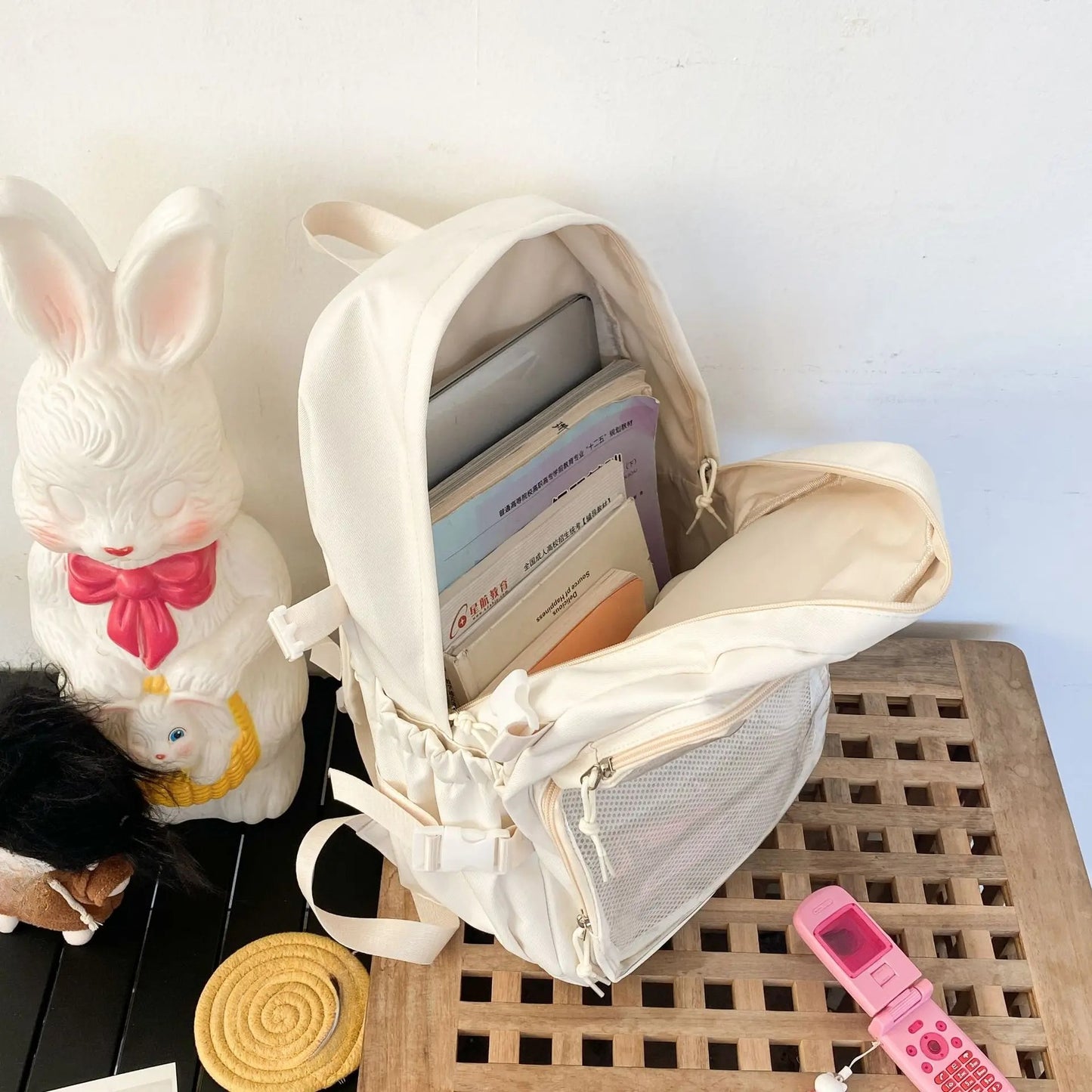 large kawaii ita backpack interior open showing A4 books laptop capacity cream white