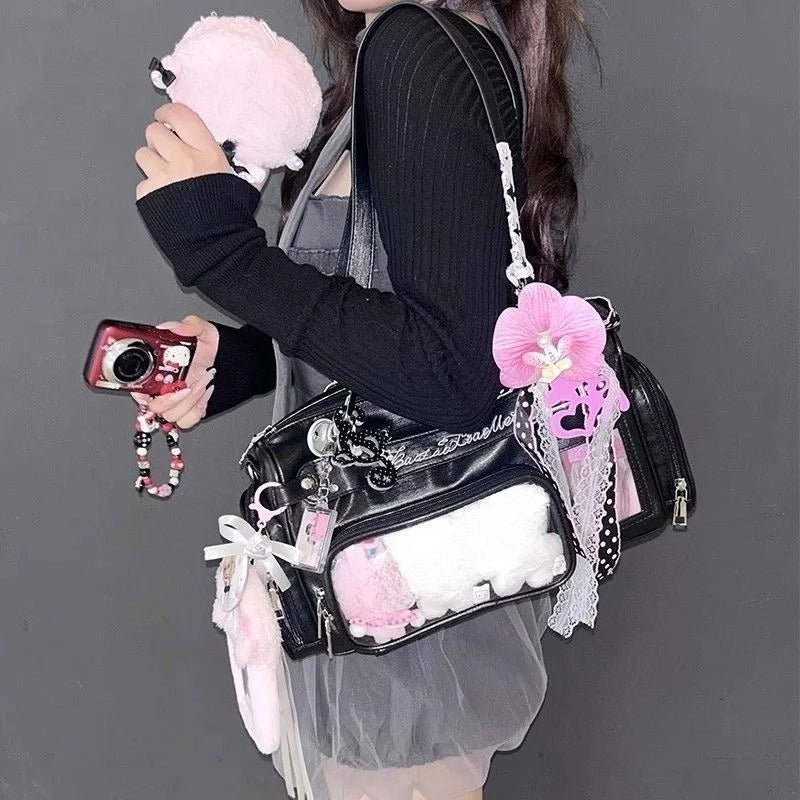 Black Boston ita bag worn crossbody with pastel display