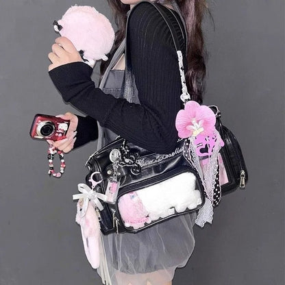 Black Boston ita bag worn crossbody with pastel display