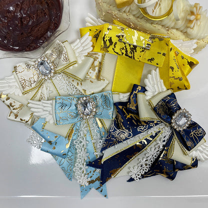 Six angel wing bow clips in all colourways flat lay