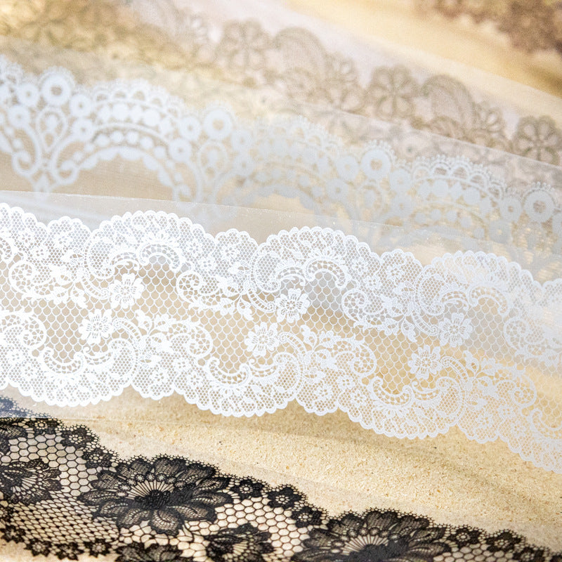 Close-up of white and black lace PET tape on sandy surface