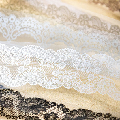 Close-up of white and black lace PET tape on sandy surface