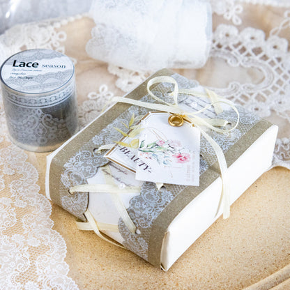 Sage green lace tape decorating a wrapped gift box