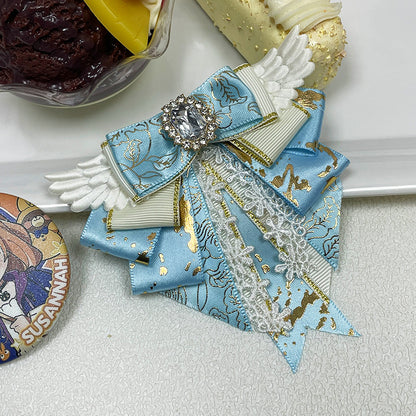 Sky blue angel wing bow clip with lace overlay and gem centre