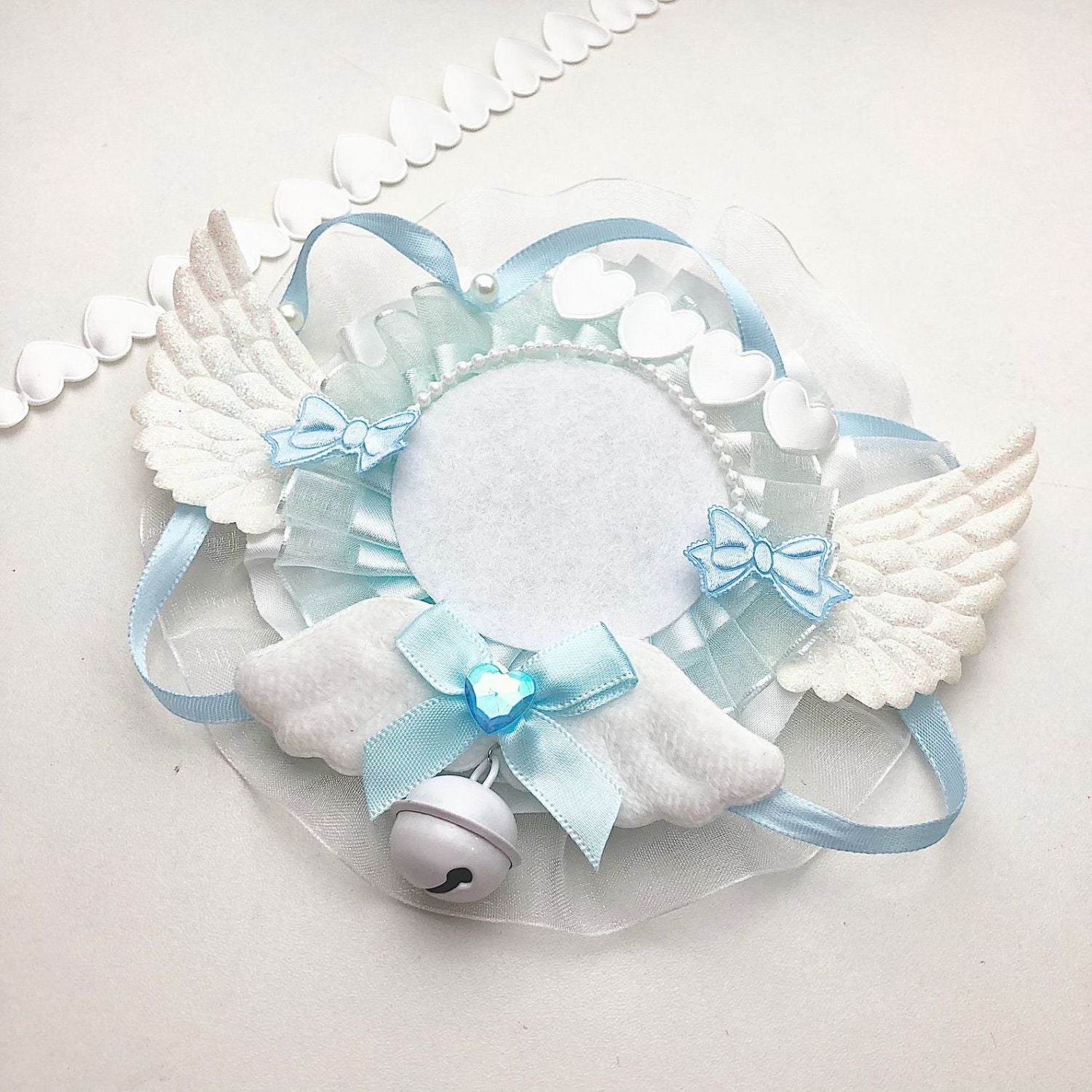 Blue white angel wing 58mm badge holder with bell closeup