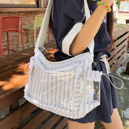 Grey stripe kawaii itabag worn crossbody, front zip pocket visible