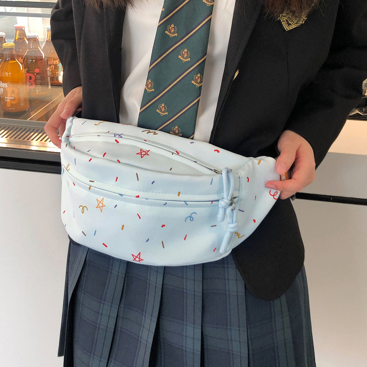 Light blue chest bag held open showing main compartment
