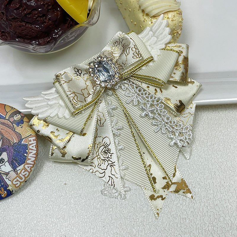 Cream ivory angel wing bow clip with gold floral jacquard tails