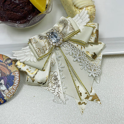Cream ivory angel wing bow clip with gold floral jacquard tails