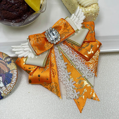 Orange angel wing bow clip with rhinestone centrepiece and lace