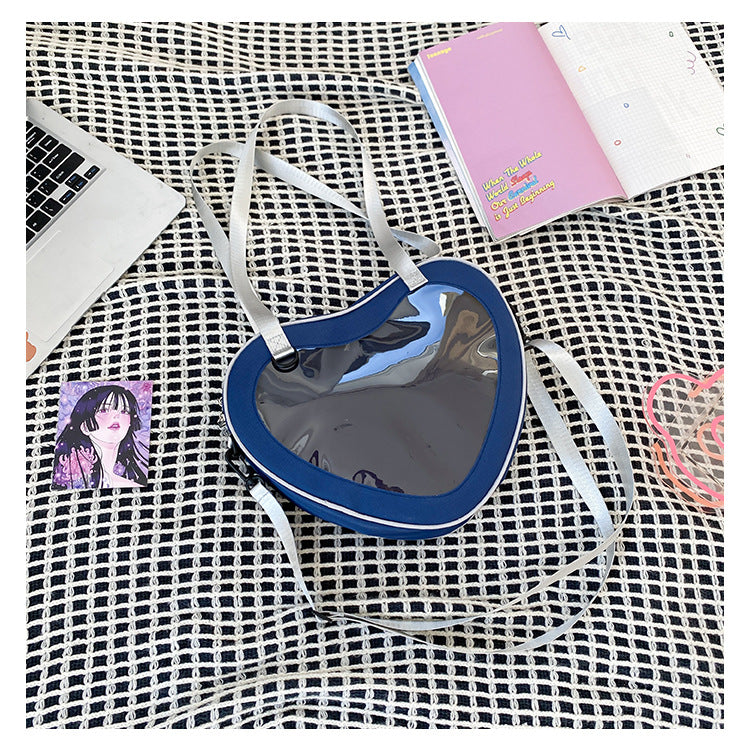 navy blue heart shaped ita bag clear window nylon crossbody worn over shoulder