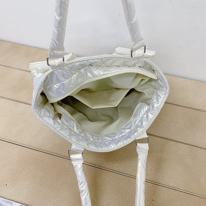 White quilted tote bag open showing lining and depth