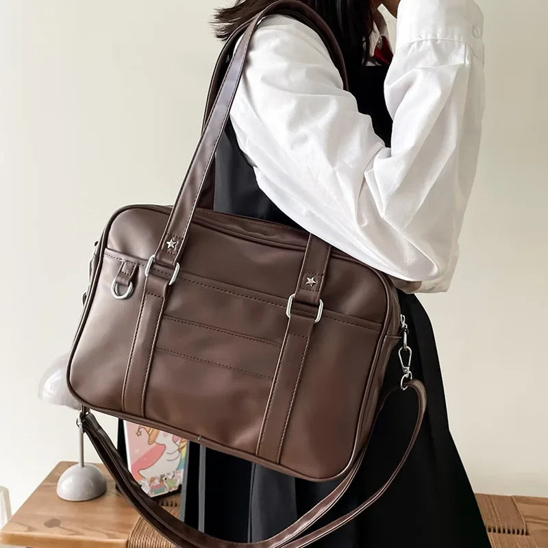JK uniform bag brown PU leather shoulder carry with star rivets and D-ring hardware side view