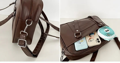 JK bag detachable crossbody strap clip hook detail and front pocket holding two phones and mini fan