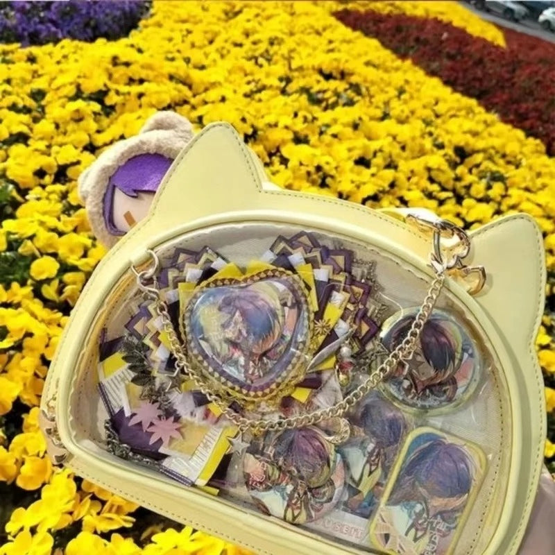 Yellow cat ita bag with colorful anime display outdoors