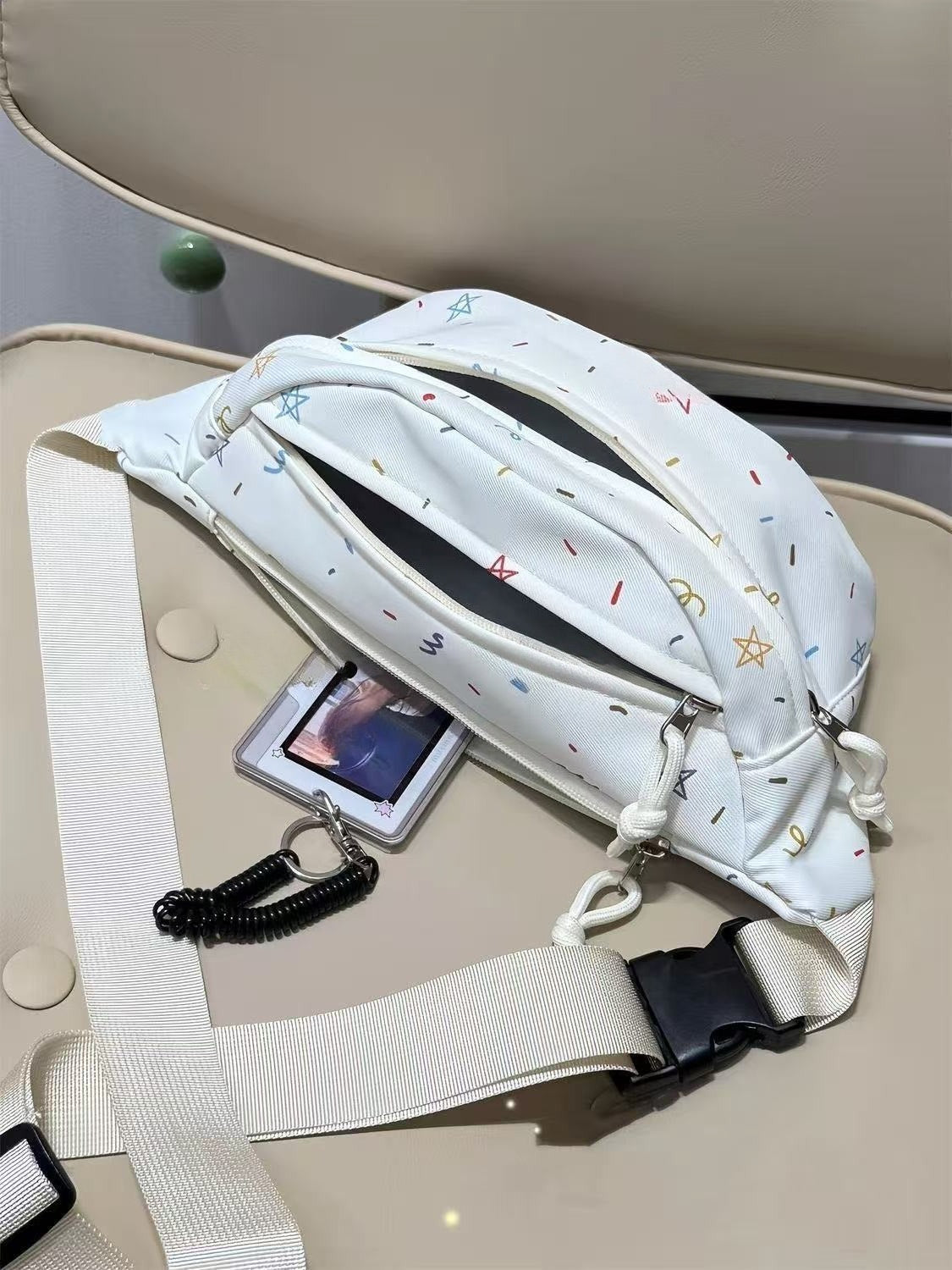Light blue chest bag open flat showing keychain ring and card holder