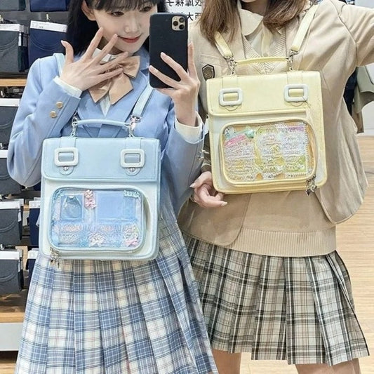 Two girls holding blue and cream satchel ita bags