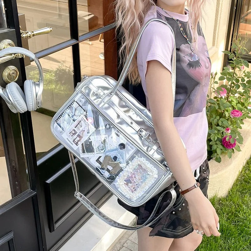 large silver metallic ita bag tote worn shoulder carry with full clear window anime display