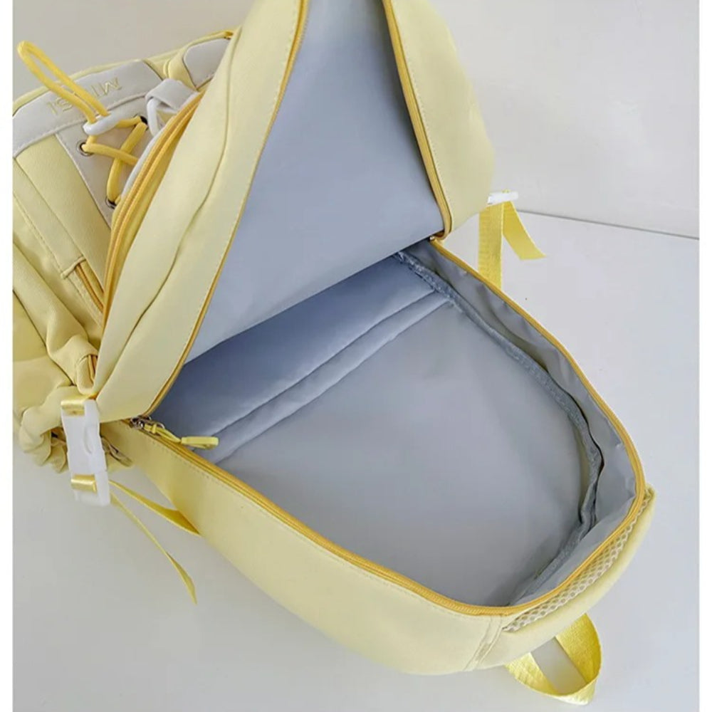 Yellow Miusi backpack open showing headphones, notebooks, and tablet inside