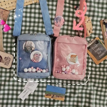 Close-up of the canvas ita bag's transparent window showing the internal mesh pocket and assorted colorful hairballs