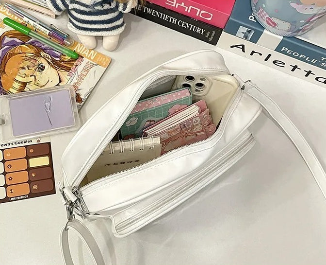 camera ita bag interior loaded with phone wallet card album showing full capacity