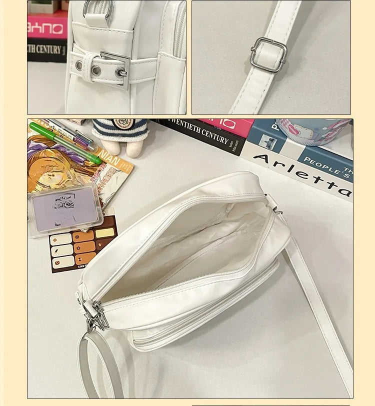 white ita crossbody bag interior open showing spacious main compartment and adjustable strap detail