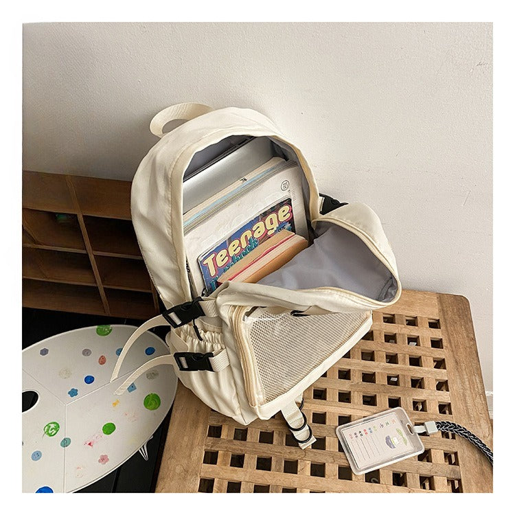 ita backpack interior loaded with laptop and books showing full capacity cream white