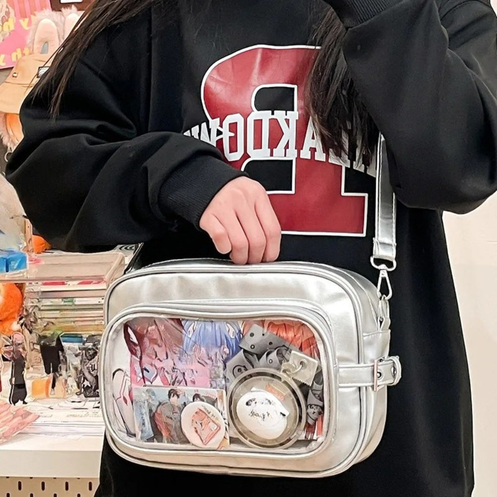 silver Y2K camera ita bag clear window crossbody with anime photocards and badges displayed