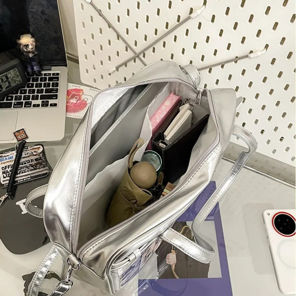large metallic ita bag interior loaded with umbrella wallet notebook showing full capacity